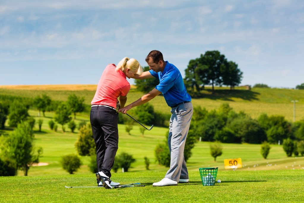 Young female golf player on course
