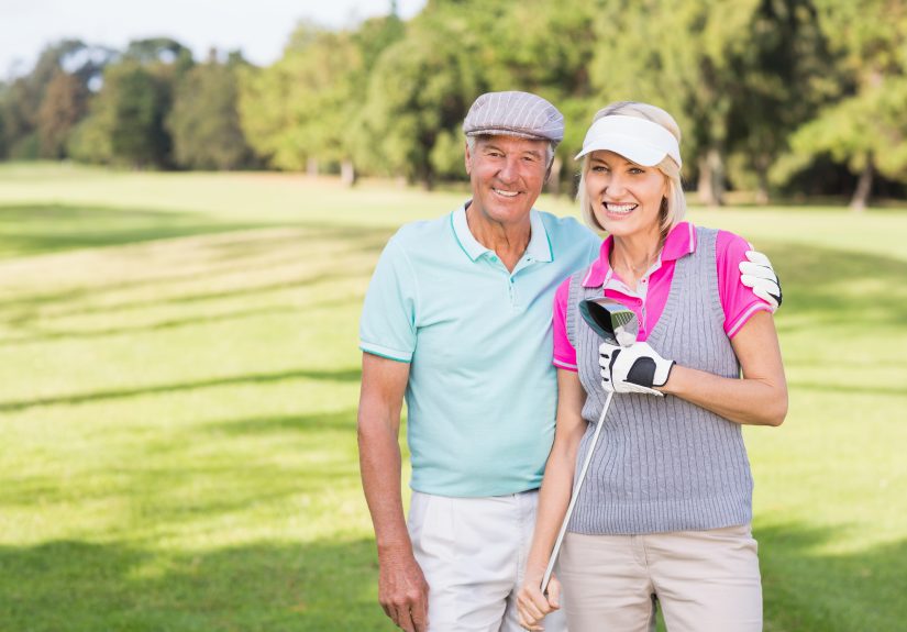 Portrait,Of,Smiling,Mature,Couple,Standing,At,Golf,Course