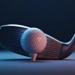 Close-up golf club poised to strike a white golf ball
